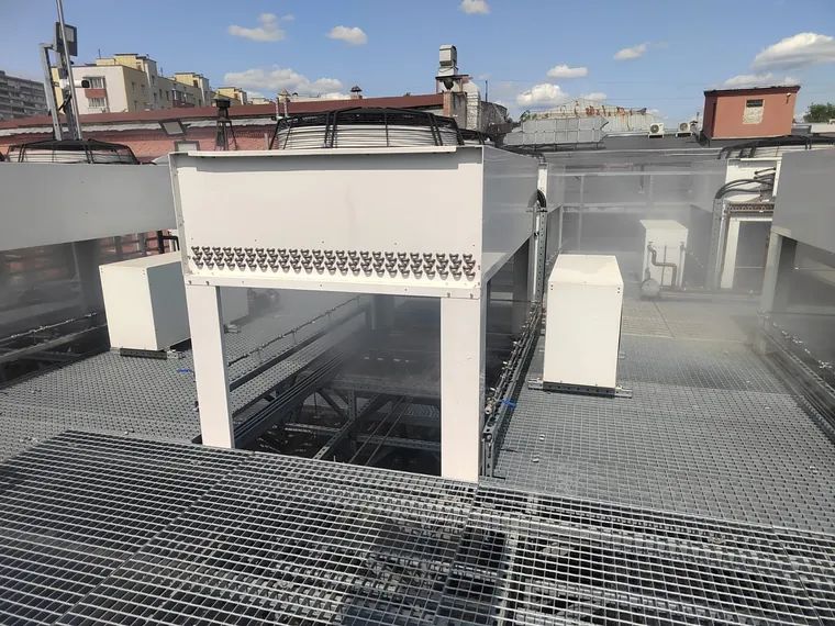Adiabatic pre-cooling of rooftop dry coolers at a data center